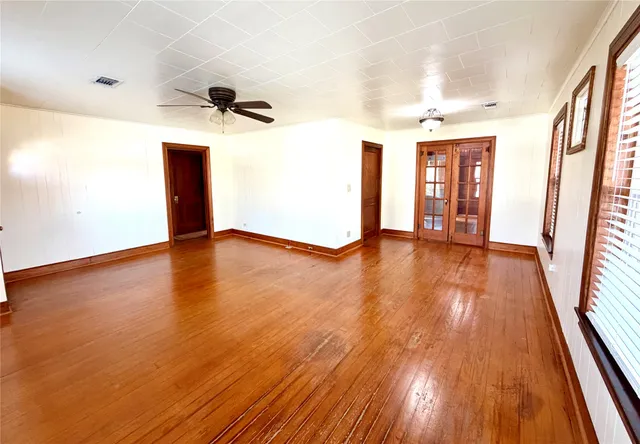 wooden floor in an empty room with a window