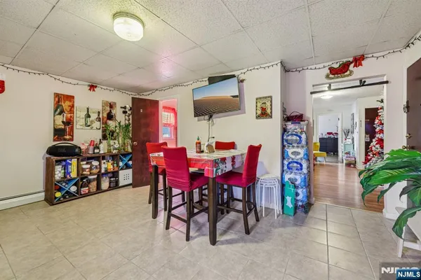 a view of a dining room with furniture and a garage