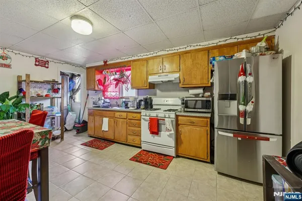 a kitchen with stainless steel appliances granite countertop a refrigerator and a stove