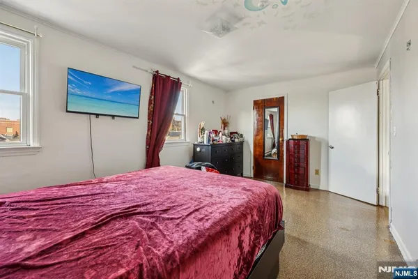 a bed room with a bed and a flat screen tv