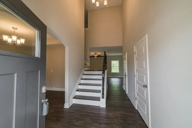 a view of a hallway with wooden floor and stairs