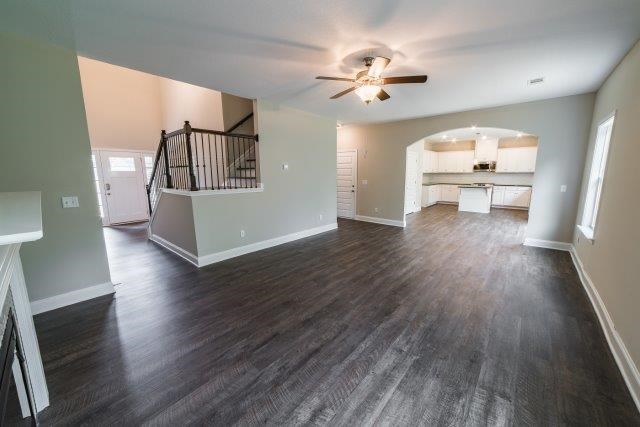 4900 Wisteria Lane Fortson, GA 31808 - Photo 5 of 9 a view of a livingroom with wooden floor and a ceiling fan