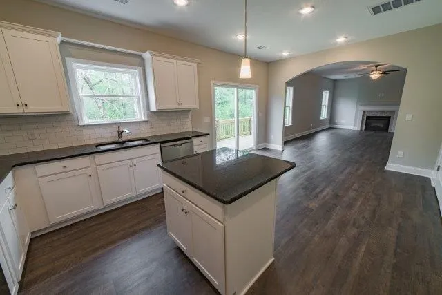 a kitchen that has a sink a window and stainless steel appliances