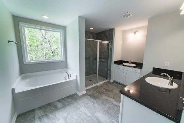 a bathroom with a tub sink and mirror