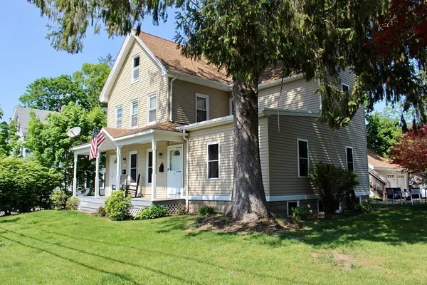 a view of house with yard