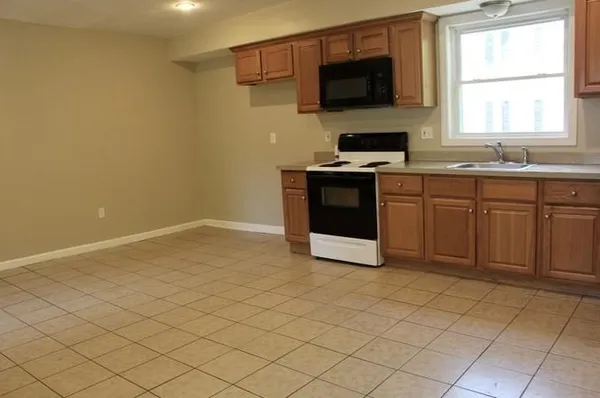 a kitchen with stainless steel appliances a sink a stove top oven and a window