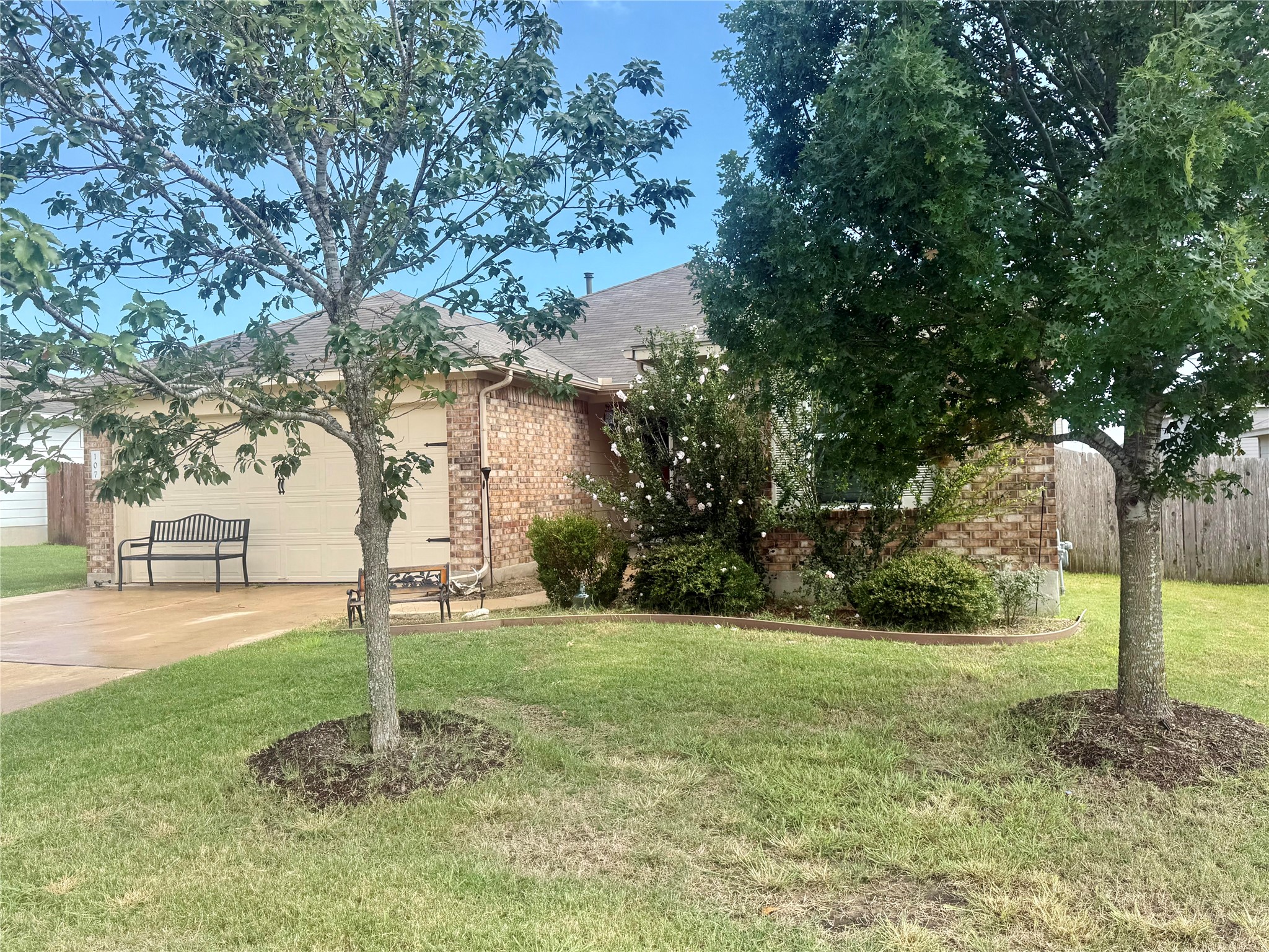 107 Jim Dandy Drive Elgin, TX 78621 - Photo 2 of 15 A two-car garage for convenience.