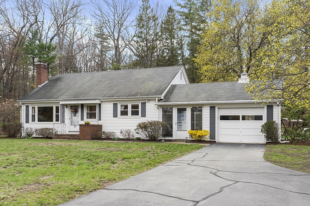 61 Harvard Road Shirley, MA 01464 - Photo 2 of 42 a front view of house with yard and trees in the background