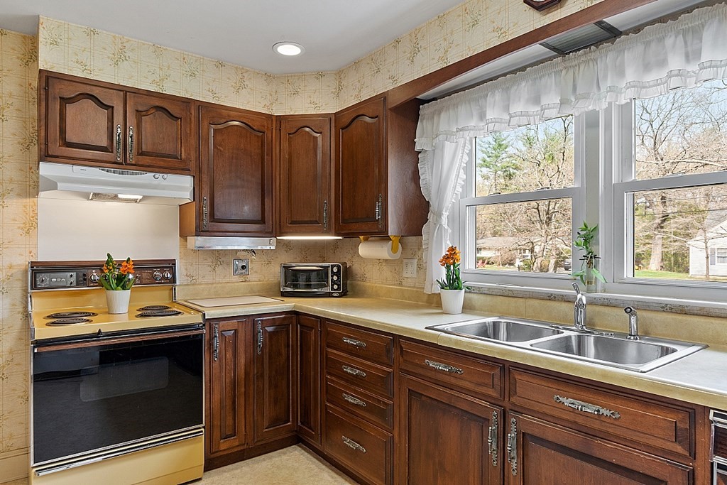 61 Harvard Road Shirley, MA 01464 - Photo 8 of 42 a kitchen with a sink a stove and cabinets