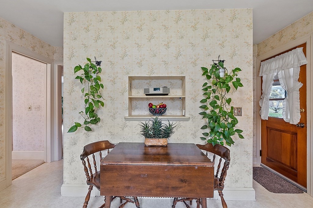 61 Harvard Road Shirley, MA 01464 - Photo 9 of 42 a dining room with furniture potted plants and wooden floor
