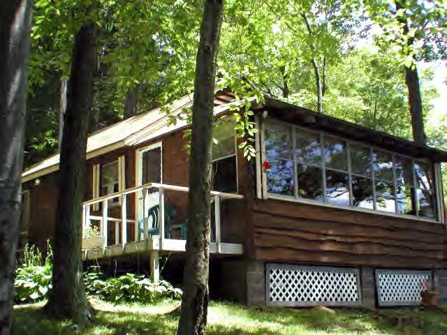122 Kibbe Road Otis, MA 01029 - Photo 1 of 8 a front view of a house with a garden
