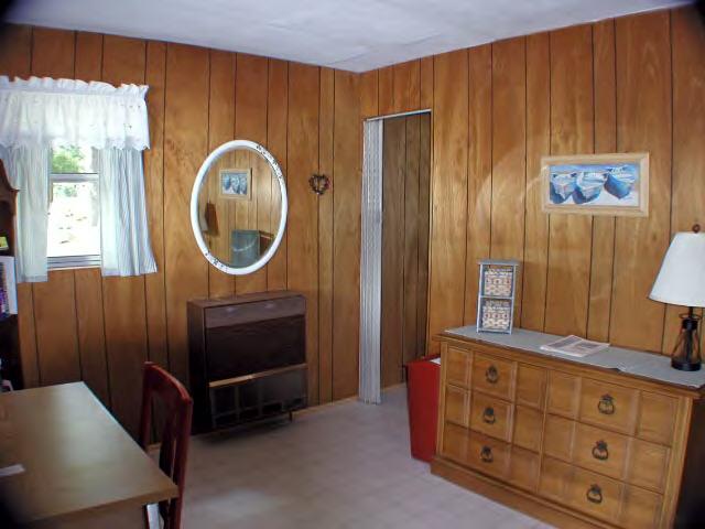 122 Kibbe Road Otis, MA 01029 - Photo 6 of 8 a room with furniture a mirror a lamp and a window