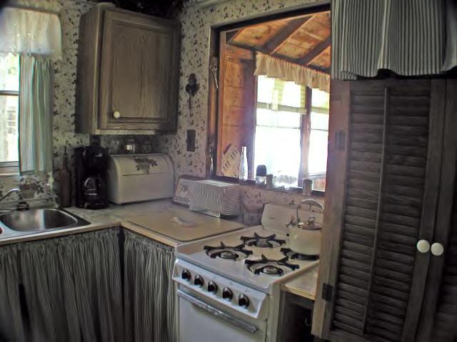 122 Kibbe Road Otis, MA 01029 - Photo 7 of 8 a kitchen with a stove a sink and a cabinets