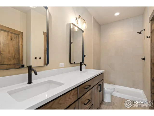 a bathroom with a sink double vanity and a mirror