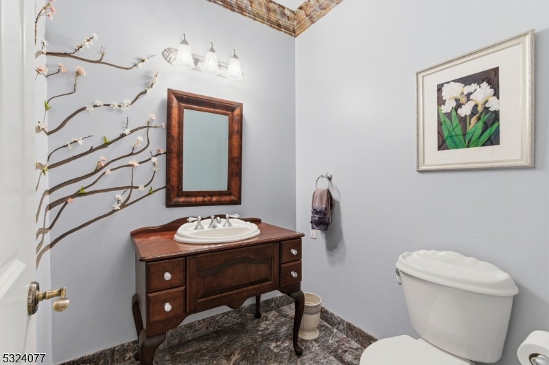 4 Deer Trail Road Saddle River, NJ 07458 - Photo 12 of 37 a bathroom with a granite countertop sink mirror vanity and toilet