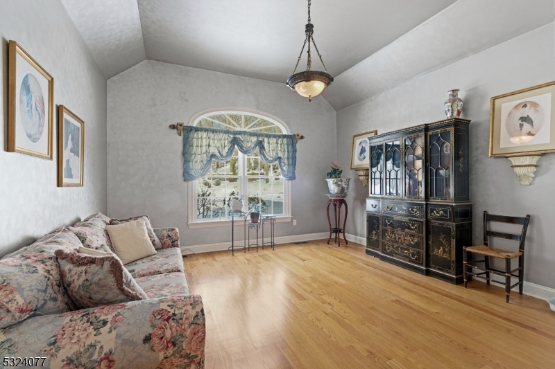 4 Deer Trail Road Saddle River, NJ 07458 - Photo 16 of 37 a living room with furniture a chandelier and a flat screen tv