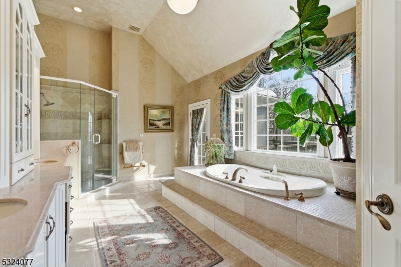 4 Deer Trail Road Saddle River, NJ 07458 - Photo 17 of 37 a spacious bathroom with a double vanity sink a mirror and a bathtub