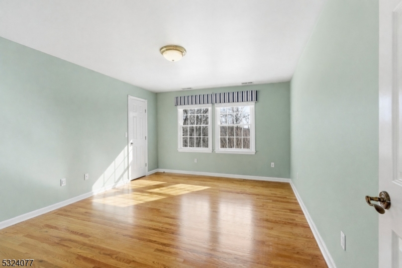 4 Deer Trail Road Saddle River, NJ 07458 - Photo 22 of 37 a view of an empty room with wooden floor and a window