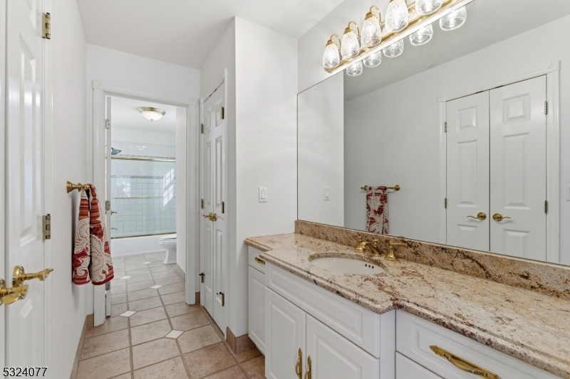 4 Deer Trail Road Saddle River, NJ 07458 - Photo 25 of 37 a bathroom with a granite countertop sink and a mirror