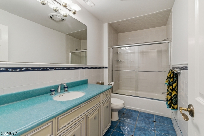 4 Deer Trail Road Saddle River, NJ 07458 - Photo 26 of 37 a bathroom with a granite countertop sink a toilet and shower