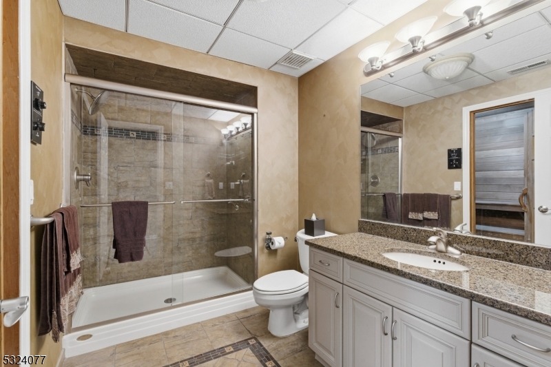 4 Deer Trail Road Saddle River, NJ 07458 - Photo 27 of 37 a bathroom with a granite countertop sink toilet and shower