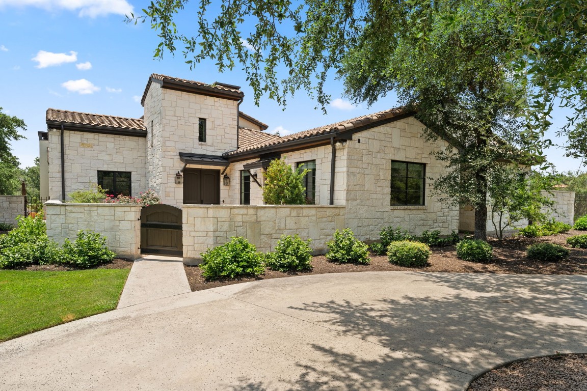 Private courtyard entry w/beautiful wood doors w/intricate details. Master craftsmanship.