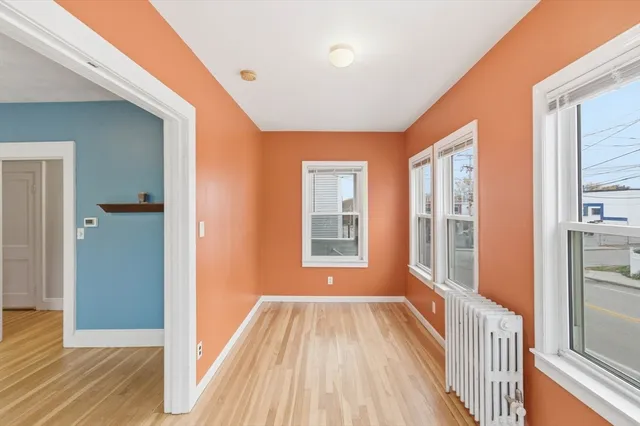 a view of a room with wooden floor and windows