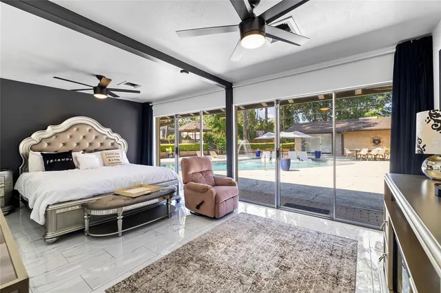 a bedroom with a bed and a large window