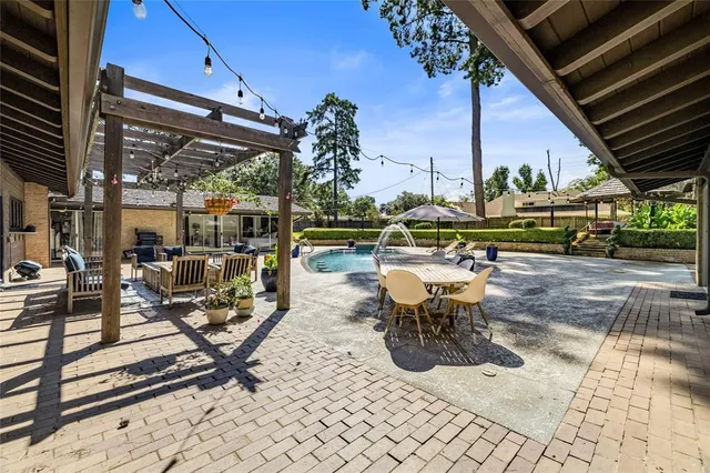 a view of a patio with a table and chairs