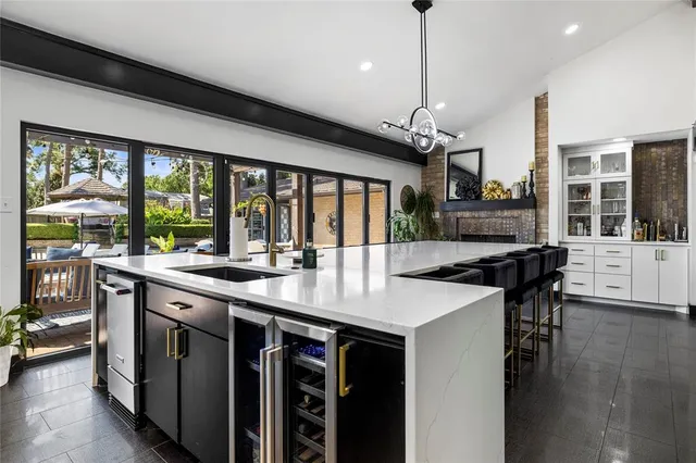 a kitchen with stainless steel appliances granite countertop a sink and a stove