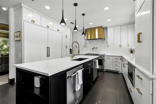 a kitchen with lots of counter space and glass door