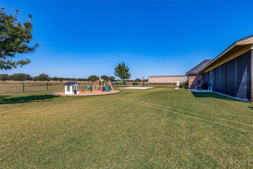 1150 Lone Star Road Bowie, TX 76230 - Photo 8 of 38 a front view of a house with a yard