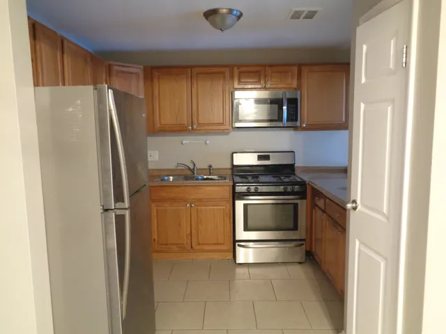 a kitchen with a refrigerator stove and microwave