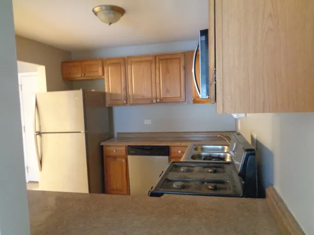 a stove top oven sitting inside of a kitchen