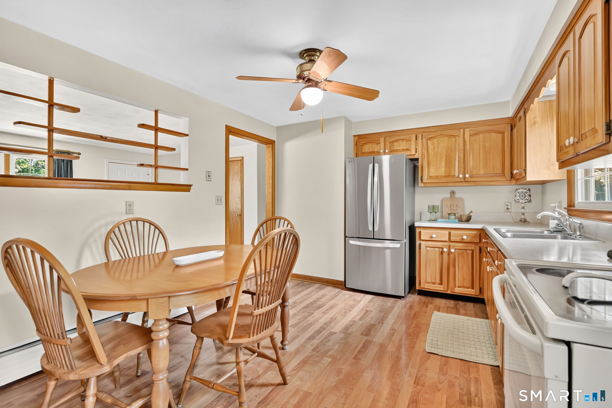 296 Phoenix Street Vernon, CT 06066 - Photo 9 of 34 a kitchen with stainless steel appliances granite countertop a dining table chairs refrigerator and sink