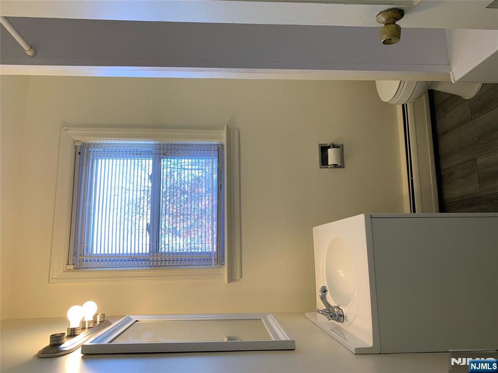 505 Schuyler Avenue, Unit 1 North Arlington, NJ 07031 - Photo 3 of 5 a bathroom with a toilet sink and mirror