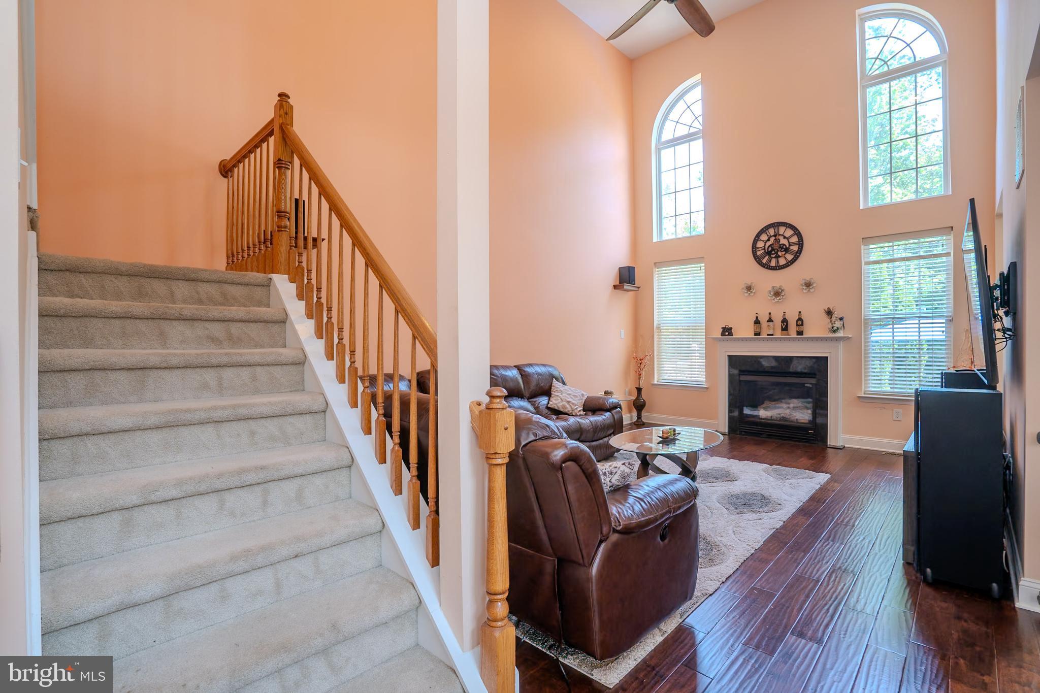 101 Beacon Drive Deptford, NJ 08096 - Photo 13 of 40 a view of a livingroom with furniture a fireplace chandeliers fan