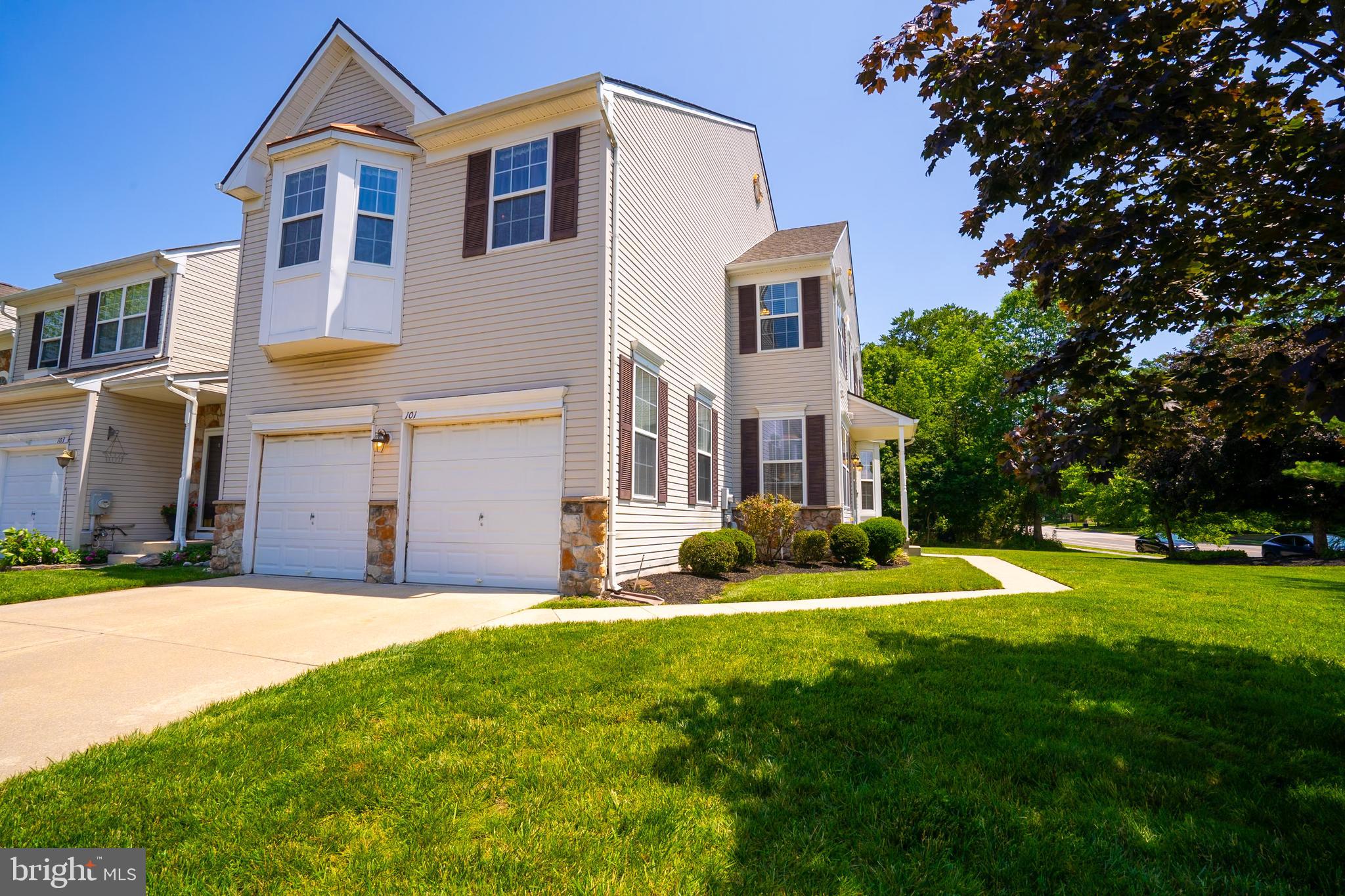 101 Beacon Drive Deptford, NJ 08096 - Photo 2 of 40 a front view of a house with a yard and garage