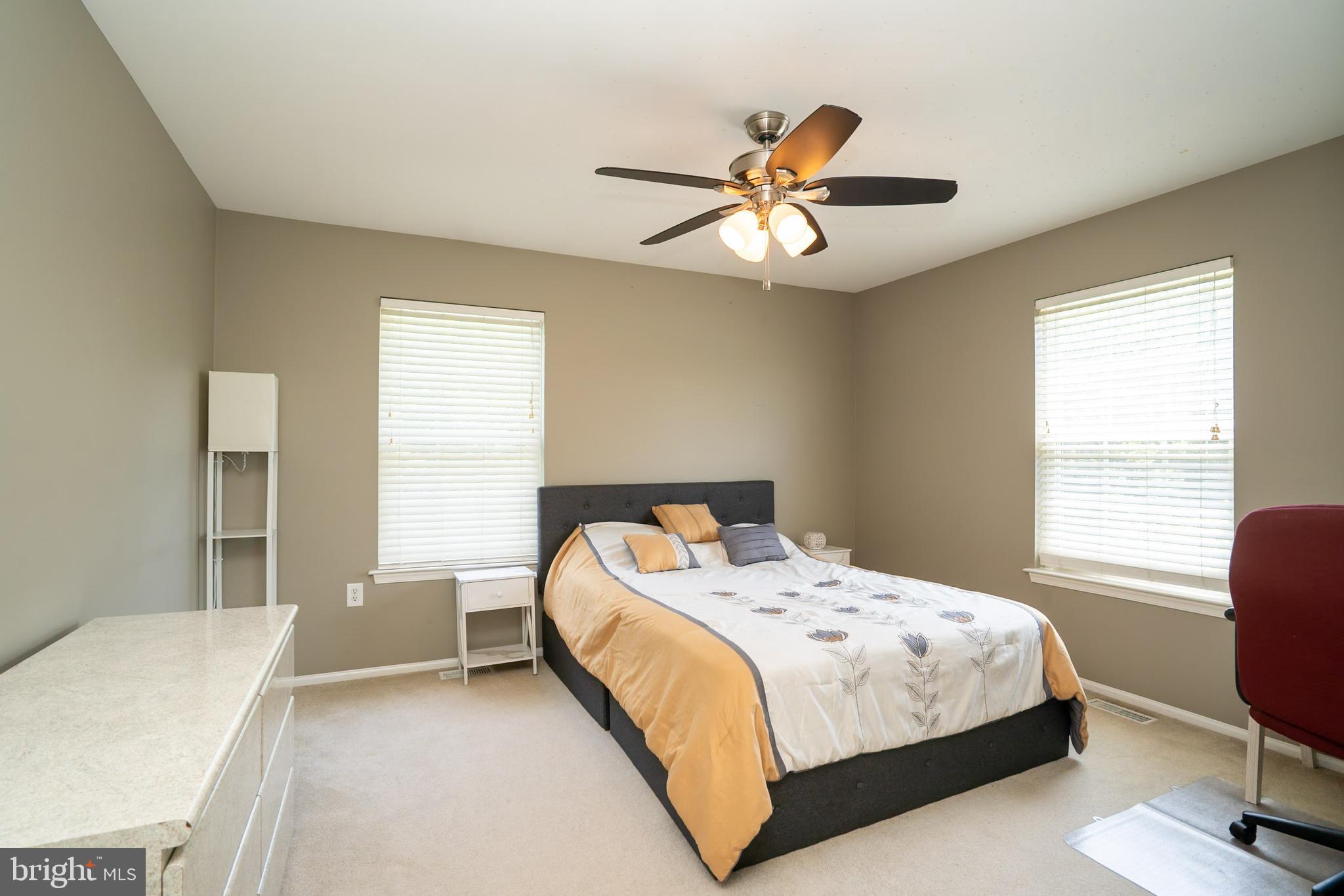 101 Beacon Drive Deptford, NJ 08096 - Photo 32 of 40 a bedroom with a bed and a chandelier
