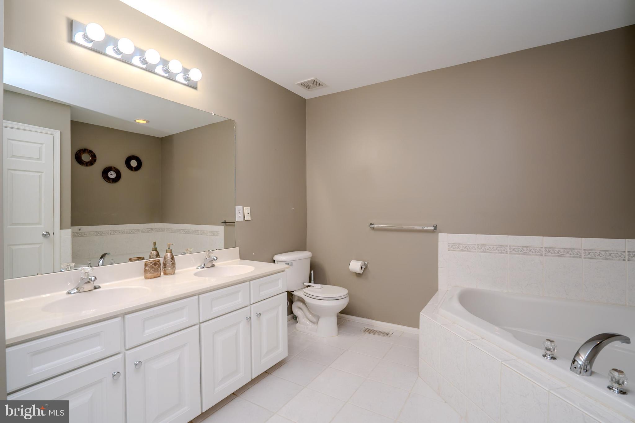 101 Beacon Drive Deptford, NJ 08096 - Photo 38 of 40 a spacious bathroom with a double vanity sink mirror and toilet