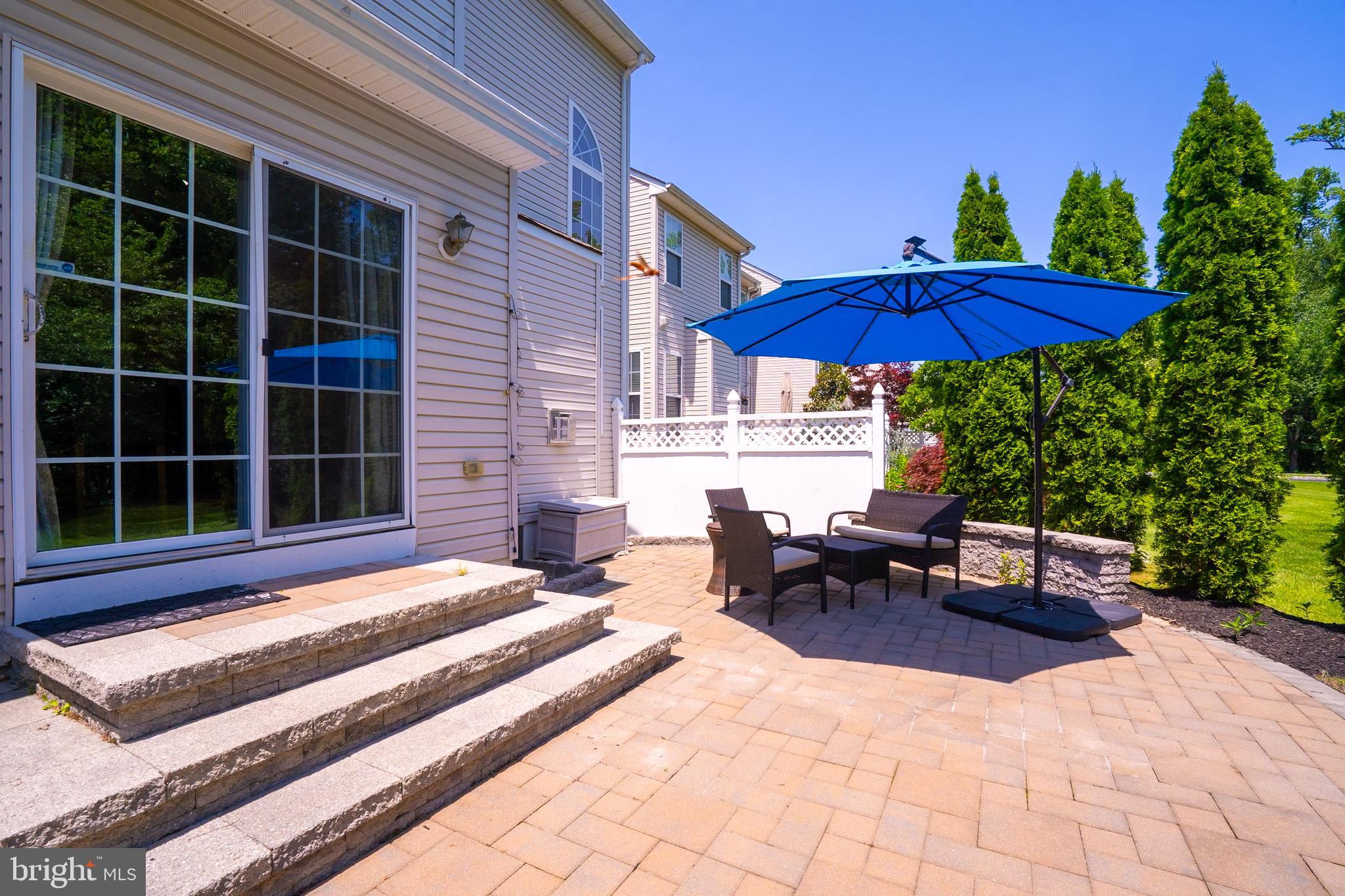101 Beacon Drive Deptford, NJ 08096 - Photo 8 of 40 a view of a patio with a table and chairs under an umbrella