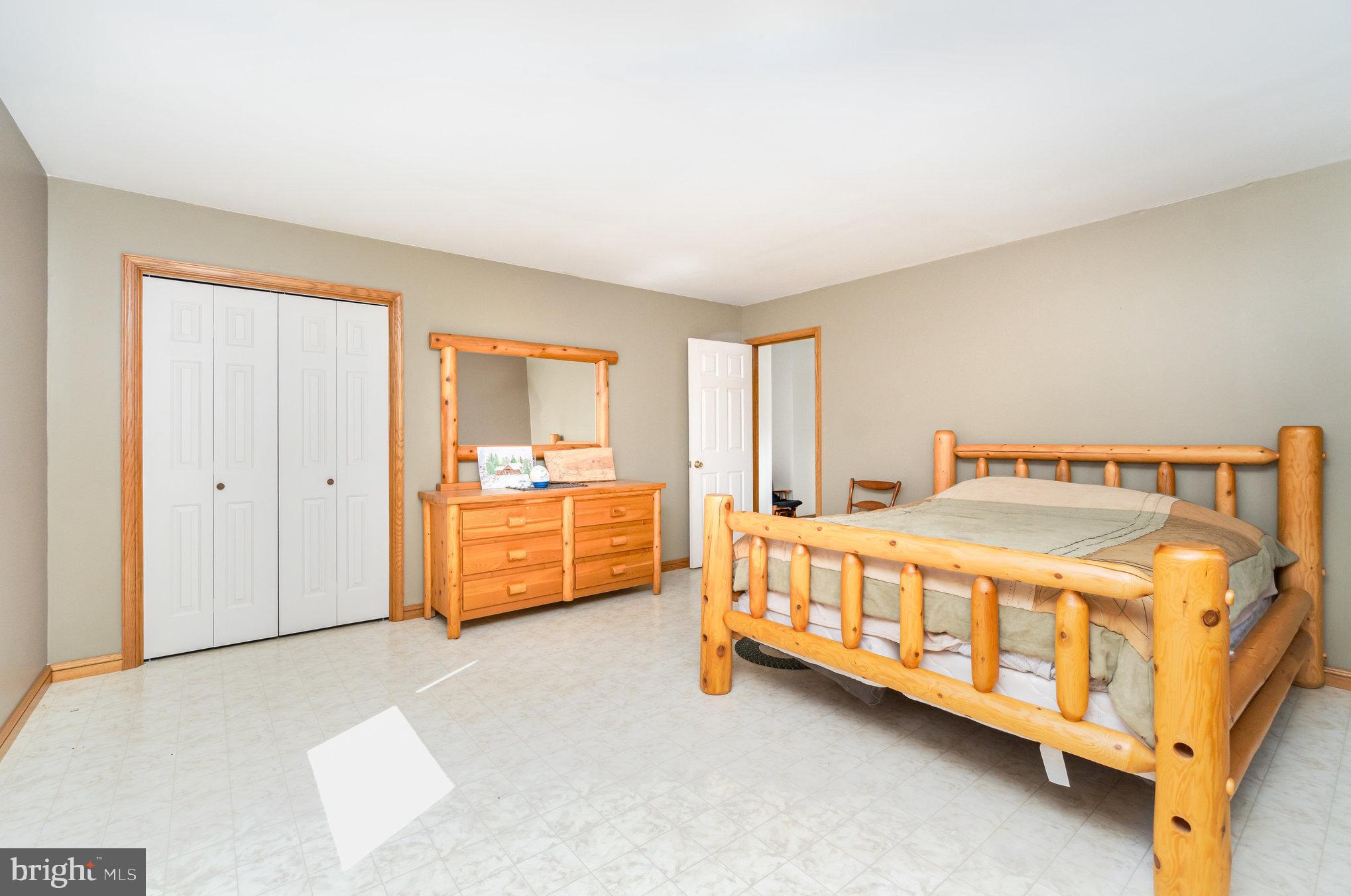 72 Quigley Road Newburg, PA 17240 - Photo 23 of 69 a large bed sitting in a room next to a cabinet