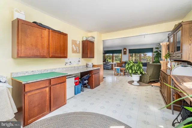 a kitchen with kitchen island a counter top space appliances and cabinets