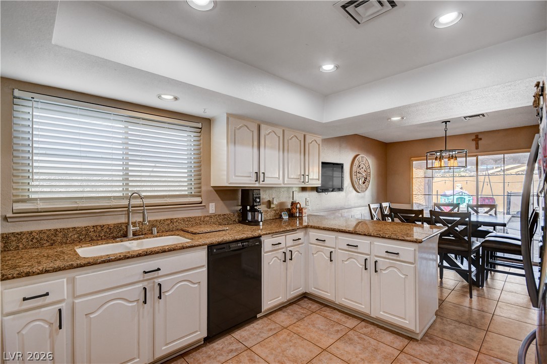 659 Arrayo Way Boulder City, NV 89005 - Photo 10 of 29 Gleaming stone countertops and classic cabinetry anchor this functional cooking space.