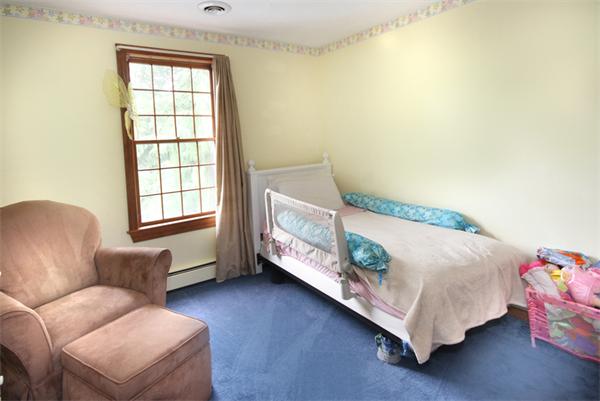 64 Cedar Street Walpole, MA 02081 - Photo 12 of 28 a bedroom with a bed couch and a window