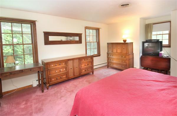 64 Cedar Street Walpole, MA 02081 - Photo 13 of 28 a bedroom with a bed dresser and a large window