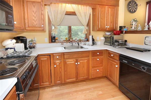 64 Cedar Street Walpole, MA 02081 - Photo 16 of 28 a kitchen with stainless steel appliances granite countertop a sink stove and cabinets
