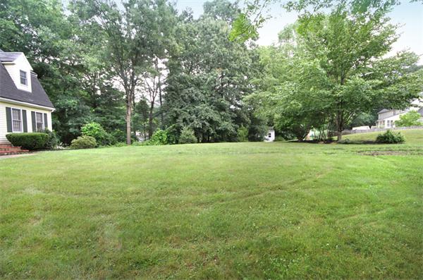 64 Cedar Street Walpole, MA 02081 - Photo 23 of 28 a view of a field with trees in the background