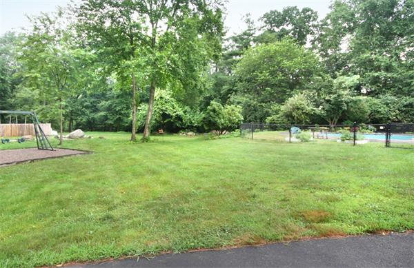 64 Cedar Street Walpole, MA 02081 - Photo 25 of 28 a view of a green field with trees in the background