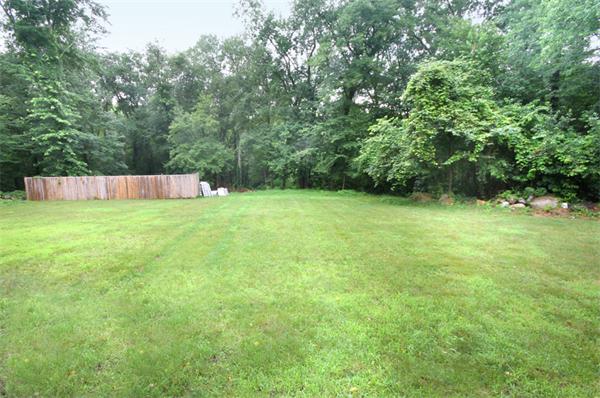 64 Cedar Street Walpole, MA 02081 - Photo 26 of 28 a view of a field with a trees in the background